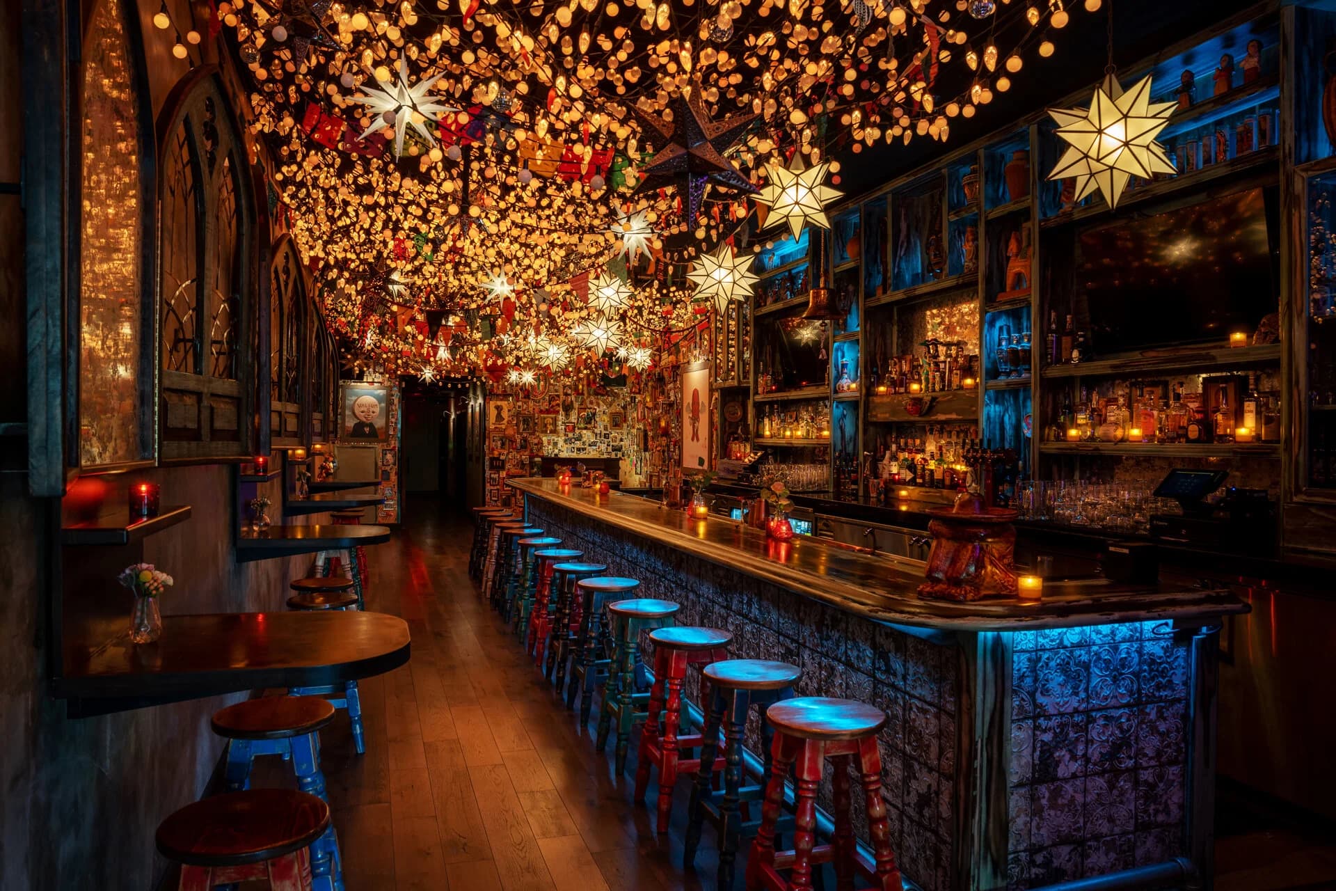 The Lucky Day bar under a ceiling of star lanterns, with red and blue stools