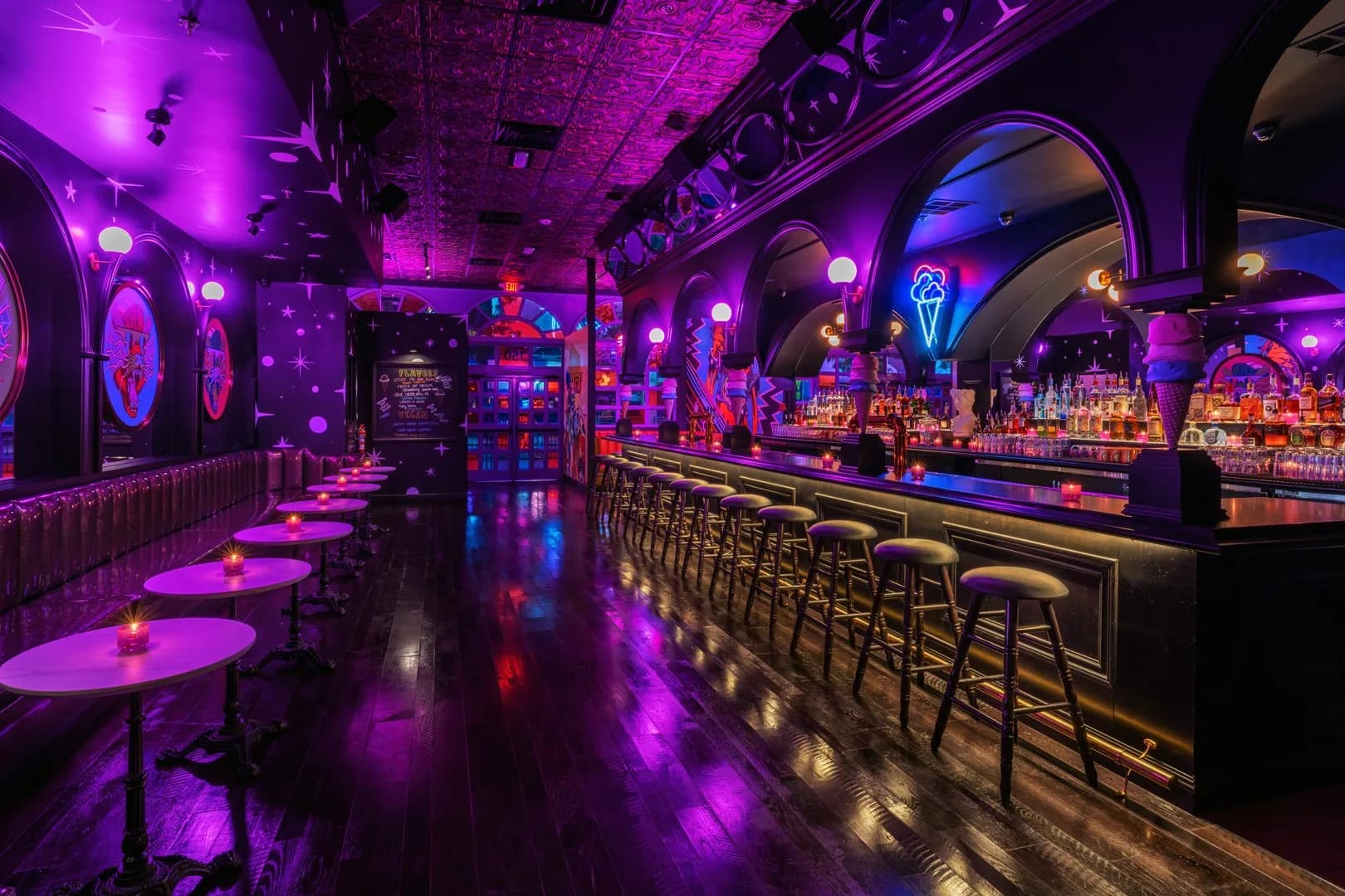 The neon-lit bar and lounge tables inside We All Scream